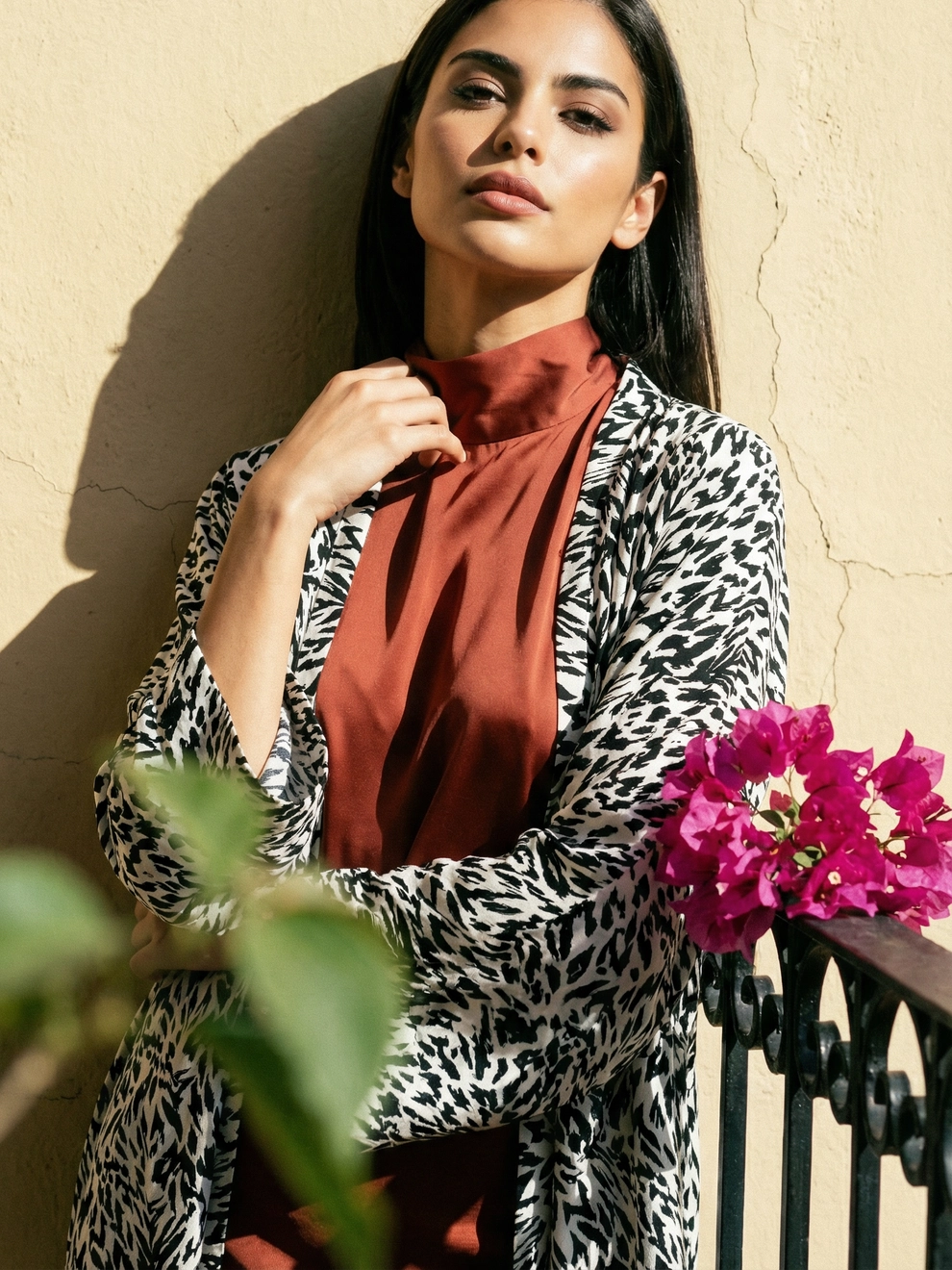 Photorealistic on-model half body photo — balcony lifestyle — created with ANZURES